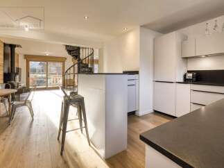 Discover the epitome of modern living in this stunning property, featuring a sleek kitchen with a stylish island and contemporary appliances.