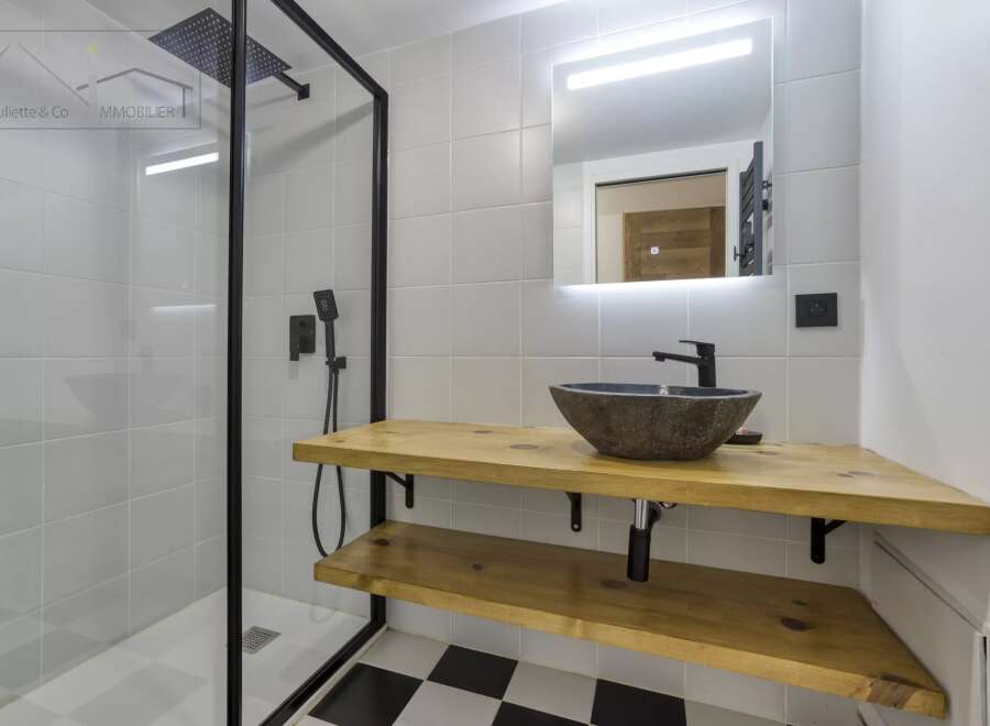 This modern bathroom features a sleek, minimalist design with a black and white checkered floor.