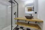 This modern bathroom features a sleek, minimalist design with a black and white checkered floor.