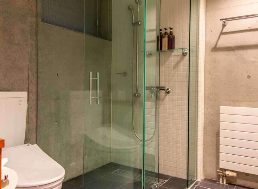 This modern bathroom features a sleek glass shower enclosure, offering a spa-like experience.