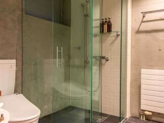 This modern bathroom features a sleek glass shower enclosure, offering a spa-like experience.