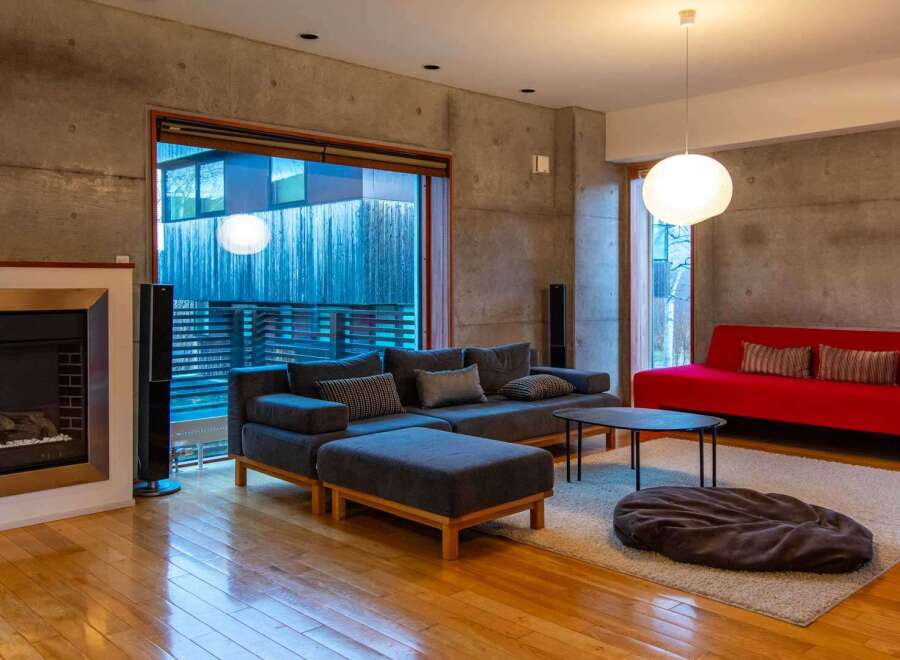 Experience modern living in this stylish property, featuring a spacious living room with a cozy fireplace and a contemporary design.