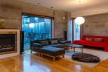 Experience modern living in this stylish property, featuring a spacious living room with a cozy fireplace and a contemporary design.