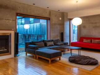 Experience modern living in this stylish property, featuring a spacious living room with a cozy fireplace and a contemporary design.