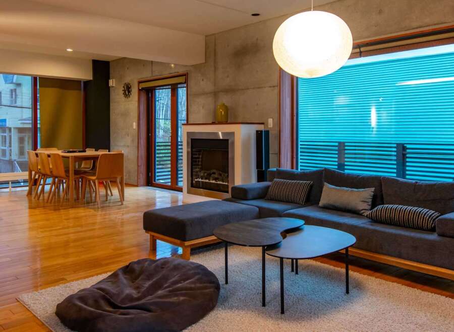 Experience modern living in this stylish property, featuring a cozy living room with a comfortable sofa and a unique coffee table set.