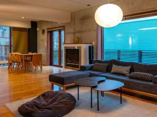 Experience modern living in this stylish property, featuring a cozy living room with a comfortable sofa and a unique coffee table set.