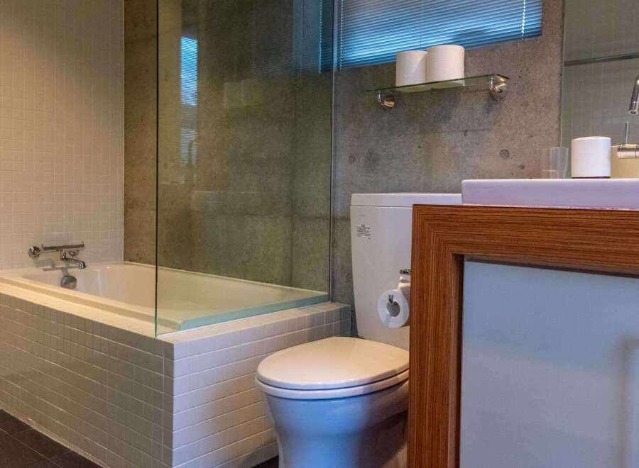 This modern bathroom features a sleek design with a soaking tub, glass shower enclosure, and a stylish vanity.