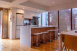 Experience modern living in this stunning kitchen! Featuring sleek white cabinetry, a stylish island with bar seating, and a bright, open layout, this space is perfect for both cooking and entertaining.