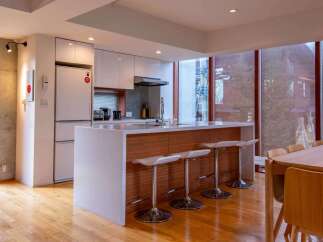 Experience modern living in this stunning kitchen! Featuring sleek white cabinetry, a stylish island with bar seating, and a bright, open layout, this space is perfect for both cooking and entertaining.