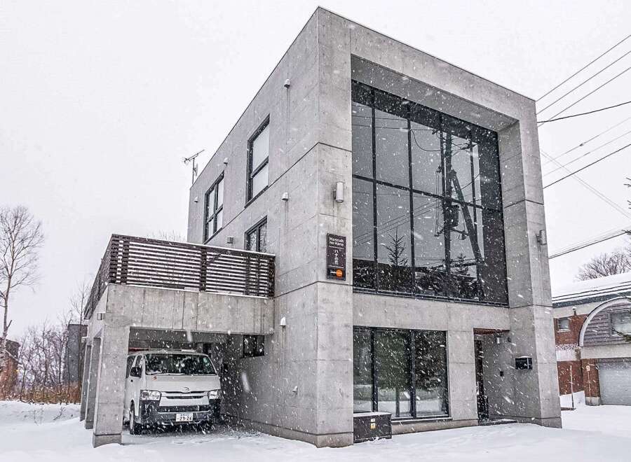 This modern architectural marvel showcases a stunning concrete facade and expansive windows, offering a contemporary living experience.
