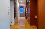 Step into this inviting property featuring a warm, wooden floor that extends throughout the hallway.