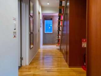 Step into this inviting property featuring a warm, wooden floor that extends throughout the hallway.