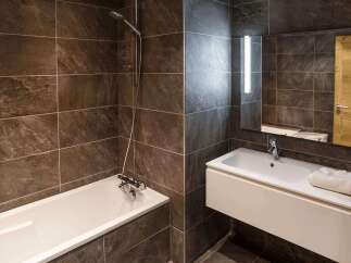 Step into a modern bathroom oasis, featuring sleek design and luxurious finishes.