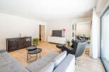 This modern living room offers a bright and airy space, perfect for relaxation and entertaining.