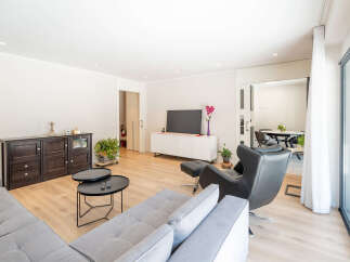 This modern living room offers a bright and airy space, perfect for relaxation and entertaining.