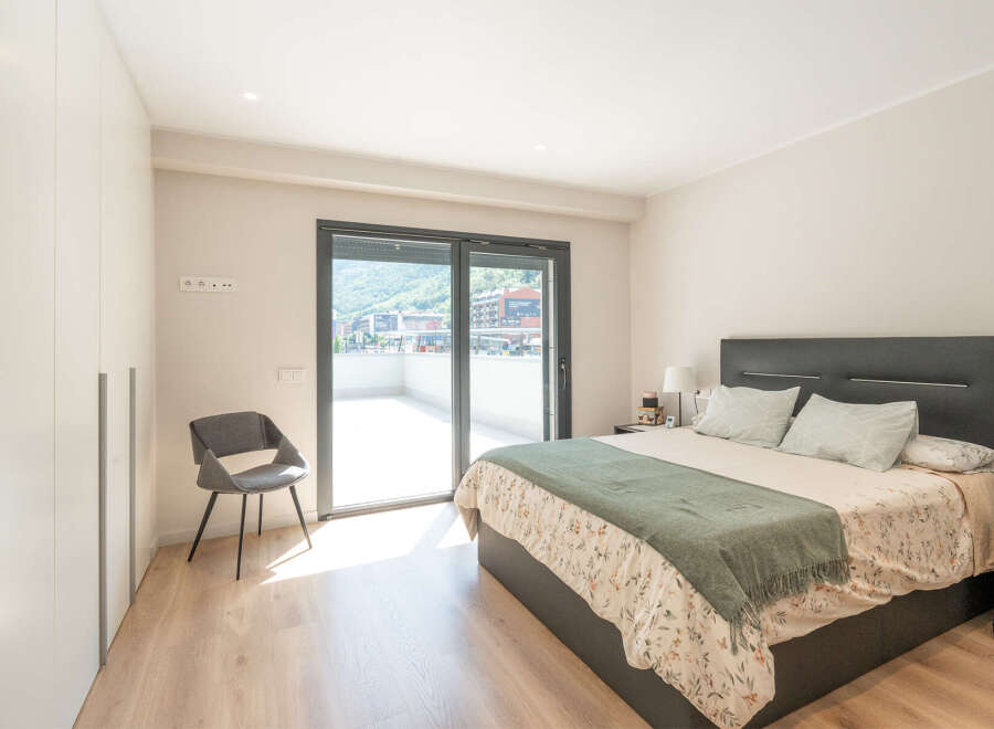 This stunning bedroom offers a serene retreat with its modern design and ample natural light.