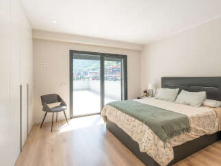 This stunning bedroom offers a serene retreat with its modern design and ample natural light.
