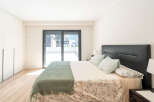 This modern bedroom boasts a sleek design with a comfortable bed and a stylish headboard.