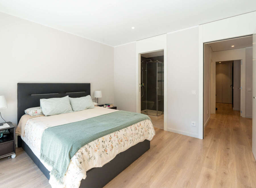 This inviting bedroom offers a serene retreat with its neutral color palette and ample natural light.