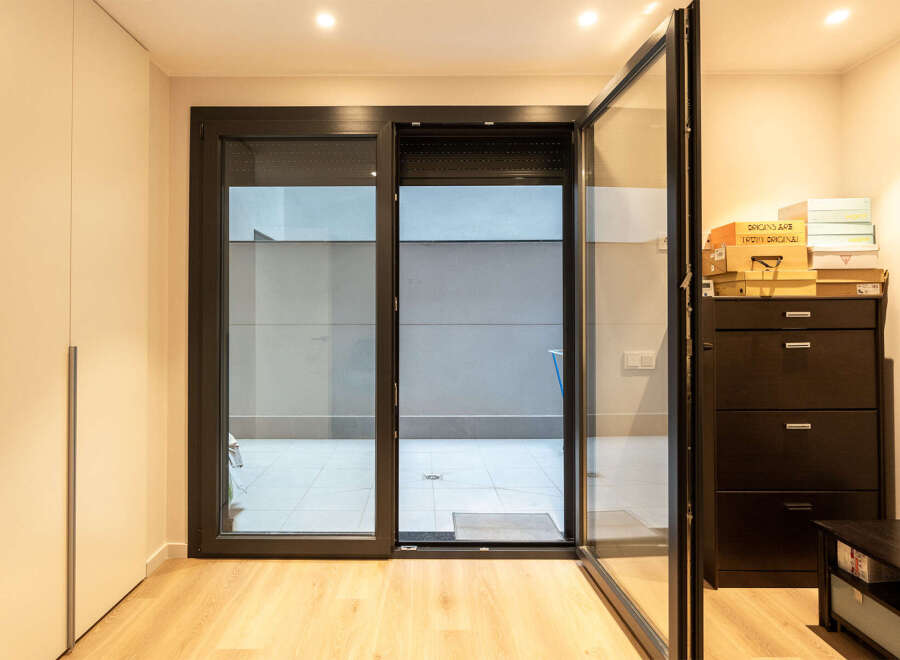 Step into modern elegance with this stunning property, featuring expansive glass doors that seamlessly connect the interior to a private outdoor space.