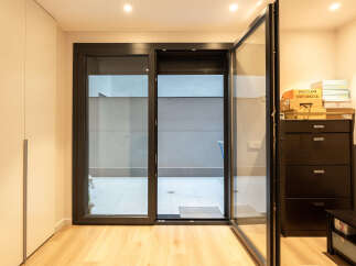 Step into modern elegance with this stunning property, featuring expansive glass doors that seamlessly connect the interior to a private outdoor space.