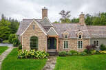 This stunning stone-clad home exudes timeless elegance.
