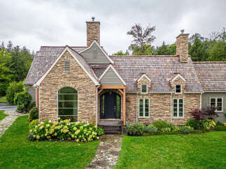 This stunning stone-clad home exudes timeless elegance.