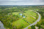 Discover a stunning rural property featuring a picturesque pond, lush greenery, and a charming house.