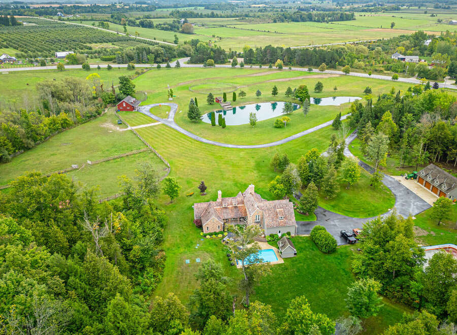 Discover the epitome of luxury living in this stunning estate, boasting a sprawling landscape and a private pond.