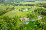 Discover the epitome of luxury living in this stunning estate, boasting a sprawling landscape and a private pond.