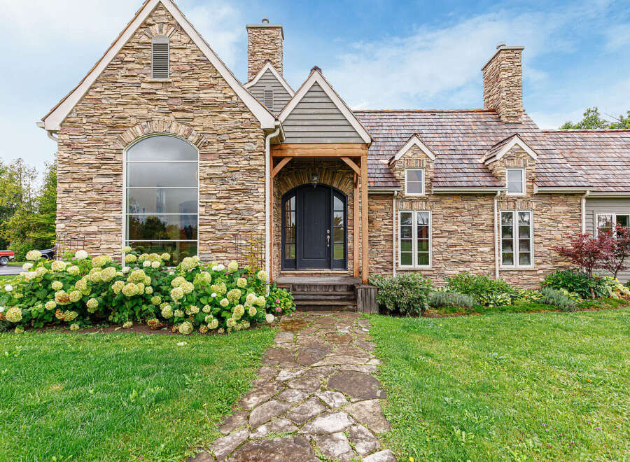 This stunning stone-clad home exudes timeless elegance and curb appeal.