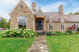 This stunning stone-clad home exudes timeless elegance and curb appeal.