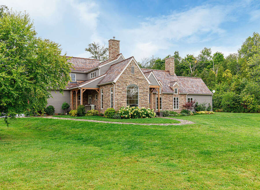 This stunning property boasts a beautiful stone exterior and a charming, inviting facade.