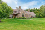 This stunning property boasts a beautiful stone exterior and a charming, inviting facade.