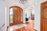 Step into luxury with this stunning property, featuring a grand entrance with a beautiful wooden door and elegant archways.