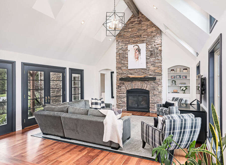 Step into luxury with this stunning living room, featuring a striking stone fireplace that serves as the focal point.