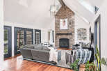 Step into luxury with this stunning living room, featuring a striking stone fireplace that serves as the focal point.