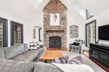 Step into luxury with this stunning living room, featuring a striking stone fireplace as the centerpiece.
