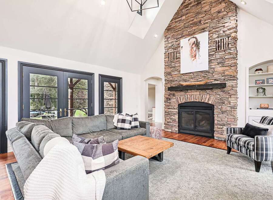 This stunning living room features a cozy fireplace with a stone facade, perfect for those chilly evenings.