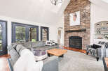 This stunning living room features a cozy fireplace with a stone facade, perfect for those chilly evenings.