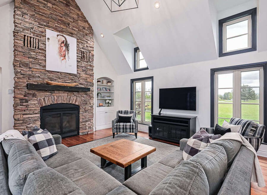 Experience luxury living in this stunning property! Featuring a cozy fireplace, a spacious living area, and large windows that offer natural light.