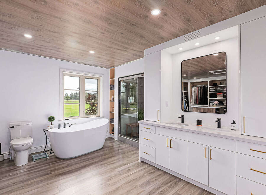 Step into luxury with this stunning bathroom! Featuring a sleek, modern design, this space boasts a beautiful freestanding tub, a spacious vanity with double sinks, and a walk-in shower.