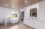 Step into luxury with this stunning bathroom! Featuring a sleek, modern design, this space boasts a beautiful freestanding tub, a spacious vanity with double sinks, and a walk-in shower.