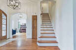Step into luxury with this stunning home featuring a grand staircase and elegant hardwood floors.