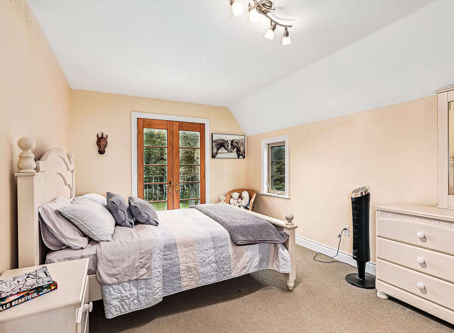 This charming bedroom offers a cozy retreat with its inviting ambiance and elegant design.