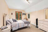 This charming bedroom offers a cozy retreat with its inviting ambiance and elegant design.