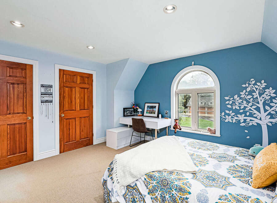 This charming bedroom features a cozy ambiance with its soft color palette and natural light.