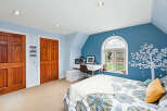 This charming bedroom features a cozy ambiance with its soft color palette and natural light.