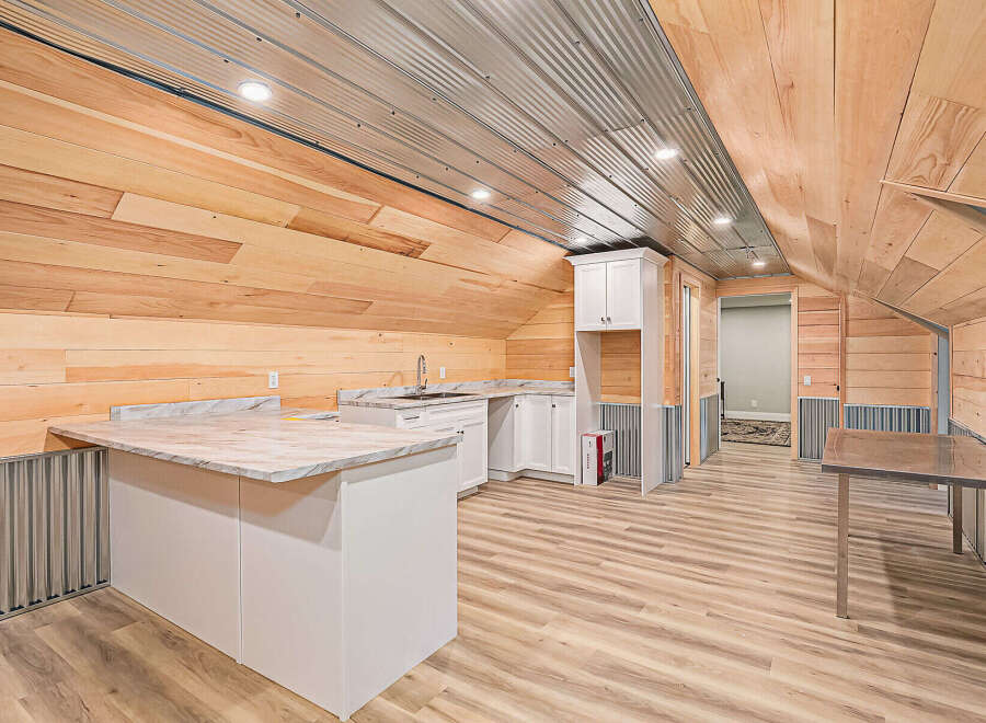 Discover the charm of this unique property featuring a stylish kitchen area with modern countertops and cabinetry.