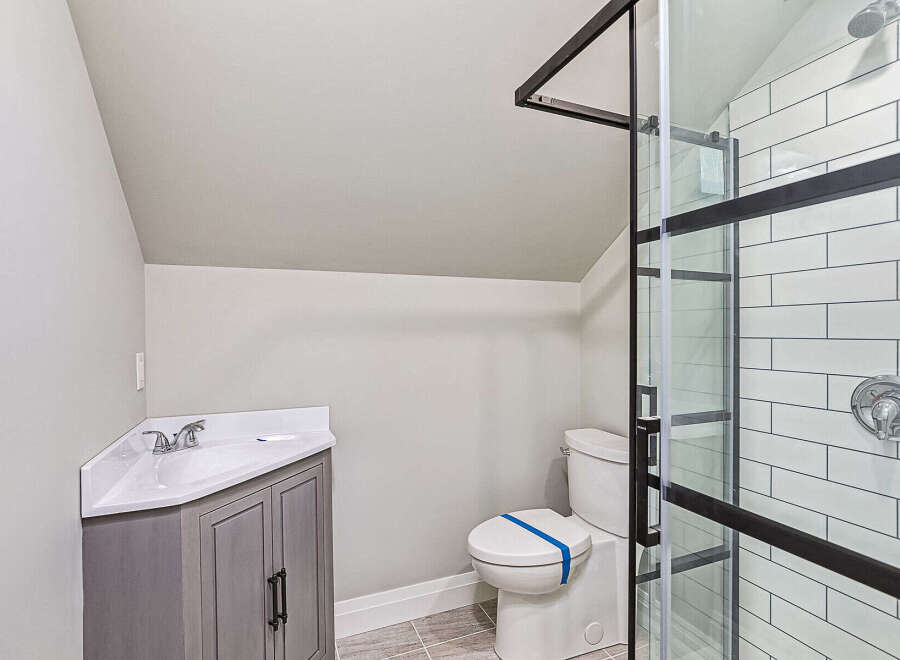 Step into this beautifully designed bathroom, featuring a modern vanity and a sleek shower enclosure.